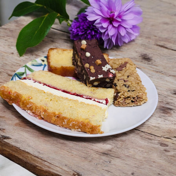 Four pieces of delicious cake in a personalised treat tin