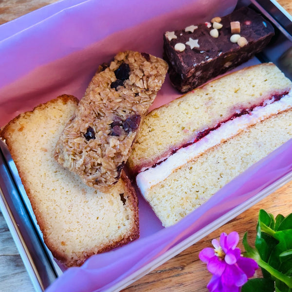 Four pieces of delicious cake in a personalised treat tin